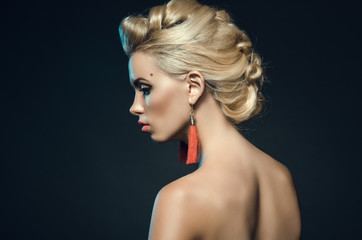 beautiful young woman in studio on a dark background. Fashion portrait