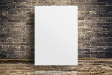 Blank white paper poster hanging at grunge brick wall and wood floor,Mock up template for adding...