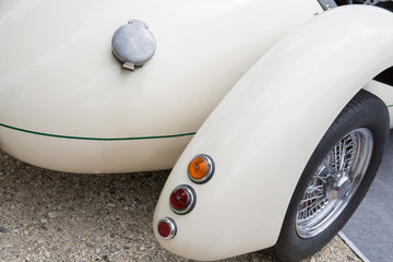 Detail of rear vintage car wheels and light - Classic vehicles white veteran
