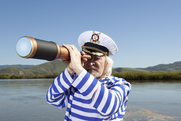 Captain looks through a telescope