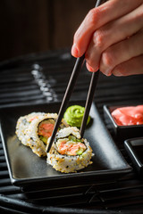 Fresh healthy made of salmon and avocado on black table