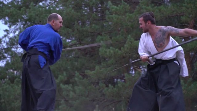 Samurai with a halberd skillfully fighting against a warrior with a katana