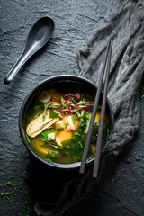 Crédence de cuisine en verre imprimé Plats de repas Tasty miso soup with salmon on black rock