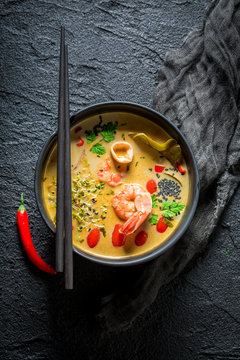 Closeup of Tom Yum soup with shrimps and coconut milk