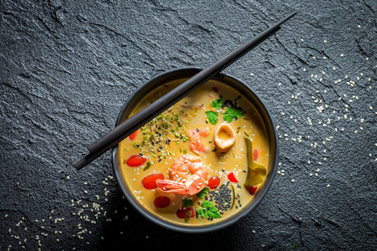 Closeup of Tom Yum soup with coconut milk and shrimps