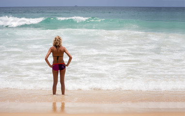 Fototapeta premium Beautiful woman bikini standing at sea beach