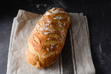 Fresh homemade bread on a black background.