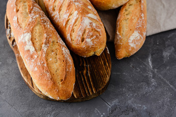 Fresh homemade bread on a black background.