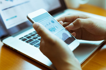 hands on keyboad of laptop and mobile phone