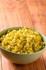 Bowl with cooked corn on the table