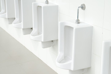 urinals in a public toilet, background. toning