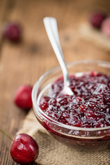 Wooden table with Cherry Jam, selective focus