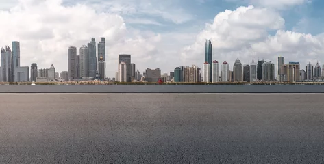Fotobehang Road pavement and city skyline © 昊 周