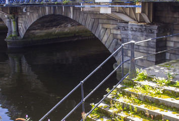 The first arch of the stone built Queen Victoria bridge over the river Lagan in Belfast northern...