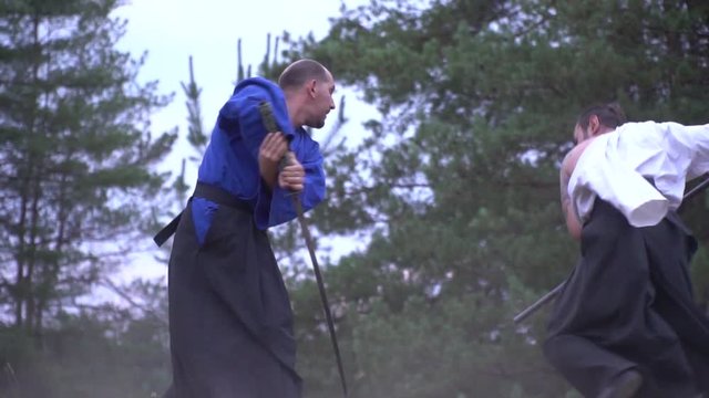 Two samurai masterfully fight in the woods