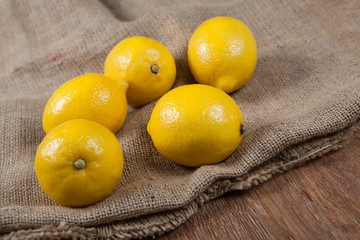 Still life of fresh lemons on a bag