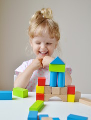 Caucasian Girl Playing with Wooden Colorful Cubes at Home Early Education Preparing for School Development