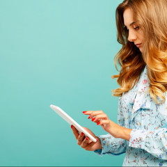 Portrait of a beautiful young woman with tablet