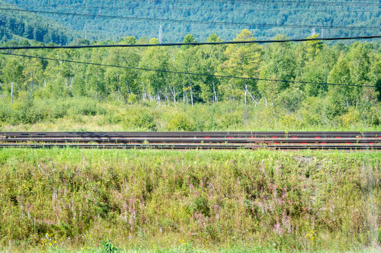 Rails in front of idyllic landscape of Lake Baikal, Siberia, Russia - on a day in summer 2017