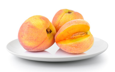 Peach in a plate isolated on a white background