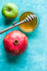 Jewish New Year apple, pomegranate and honey closeup