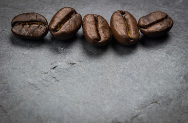Coffee beans on nature black stone
