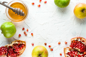 Frame of pomegranate, pomegranate seeds and apples with honey for the Rosh Hashanah