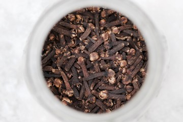A close up of a bowl full of aromatic cloves 