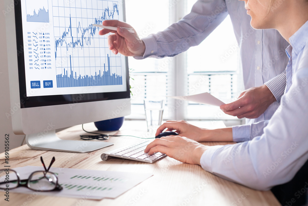 Wall mural traders with forex trading charts and graphs on computer screen
