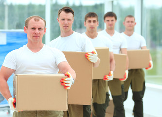 team of builders with boxes of building materials