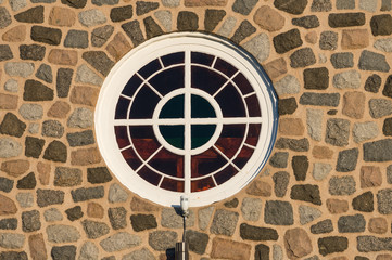 Round window on a stone wall