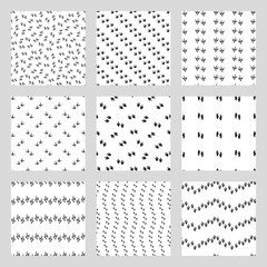 Minimal seamless patterns with dinosaur foots. Black and white colors. Vector illustration.
