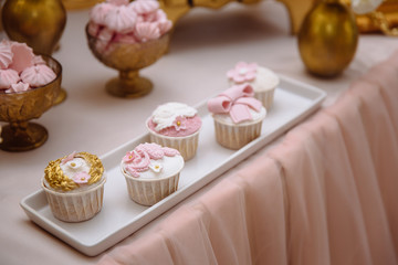 Candy bar. Table with sweets, buffet with cupcakes, candies, dessert.