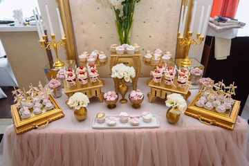 Candy bar. Table with sweets, buffet with cupcakes, candies, dessert.