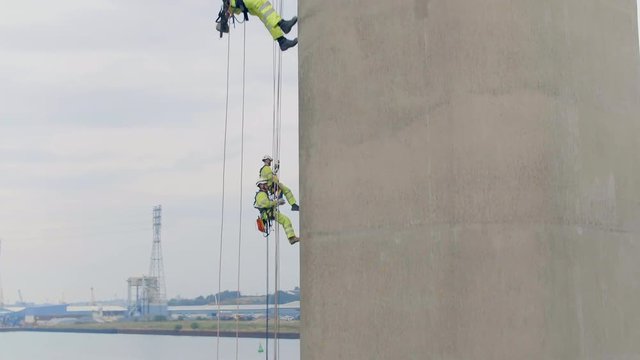 Safety Inspectors Working at Height on a Concrete Bridge Checking for Cracks, Wear and Tear