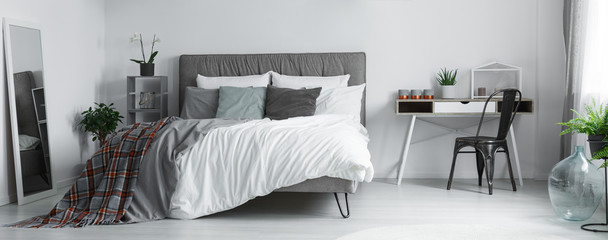 Patterned blanket in grey bedroom