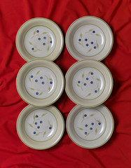 italian hand painted plates on a red cloth