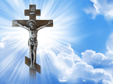Silhouette of the crucified Jesus Christ on the cross against the blue sky. The Biblical prophet is a symbol of death. Calvary, Christmas, Easter background.
