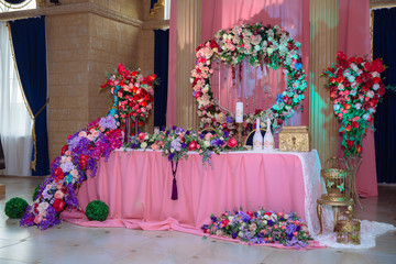 Beautiful decorated wedding restaurant for marriage. Colorful decoration for celebration. Beauty bridal interior. Concept of style of banquet hall