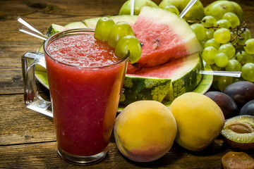 Watermelon smoothies, peaches, grapes, plums. From the side