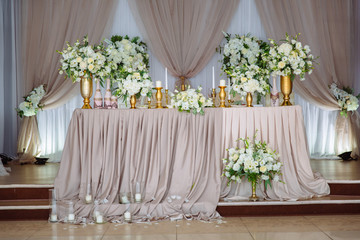 Beautiful decorated wedding restaurant for marriage. Colorful decoration for celebration. Beauty bridal interior. Concept of style of banquet hall