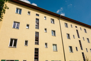 Fototapeta na wymiar yellow apartment house with blue sky