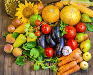 A lot of vegetables and fruits on a wooden surface. Big harvest.
