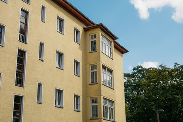 Fototapeta na wymiar yellow corner building with glass balconies