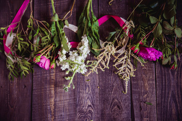 pink flowers on dark wooden background