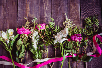 Fototapeta premium pink flowers on dark wooden background