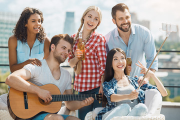 Group of friends having barbecue party on the roof