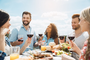 Group of friends having barbecue party on the roof