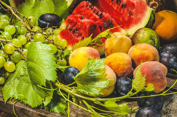 Slices of watermelon. Grapes, peaches and plums. close-up - Powered by Adobe