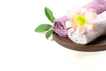 Obraz na płótnie Canvas Spa setting of towel, flower isolated on white background with copy space.